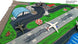 Model of an airport with planes and vehicles on a green field
