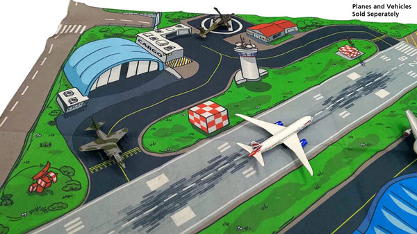 Model of an airport with planes and vehicles on a green field
