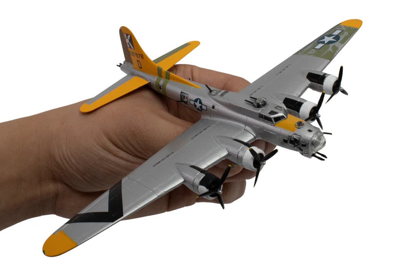Model airplane held in a hand with a white background