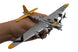 Model airplane held in a hand with a white background