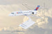 A Delta-branded model airplane displayed on a stand against a cloudy sky background, with measurement lines and labels showing dimensions such as 7.5 in, 7 in, and 11.