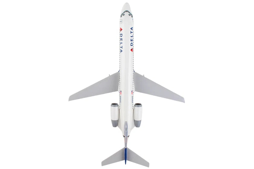 A Delta Airlines model jet airplane viewed from directly above, featuring a white fuselage with blue and red logo details, gray wings, and engines, set against a solid white background.