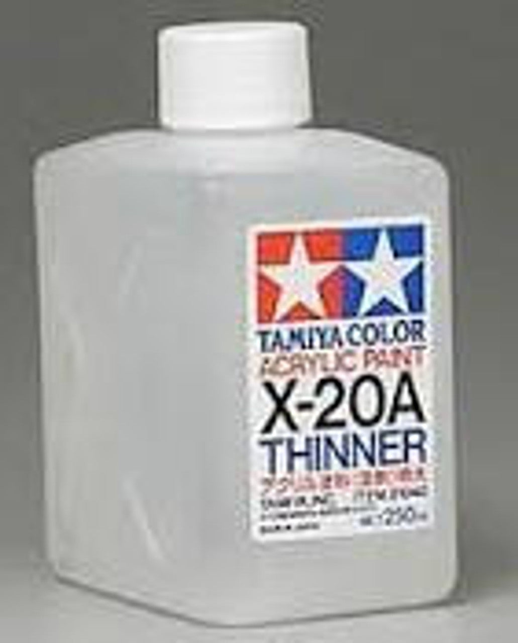 A 250mL bottle of Tamiya X-20A acrylic paint thinner with labeling that includes the product name and information.