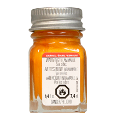 A 1/4 oz bottle of Testors Turn Signal Metallic Enamel Paint in orange color with a label warning that it is flammable.