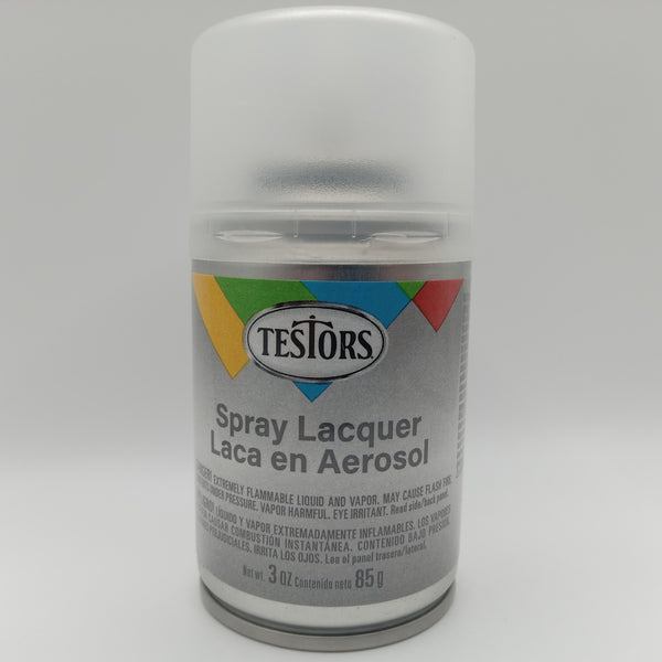 A 3 oz spray can of Testors Lacquer Dullcoat in a clear finish, with label and branding visible.
