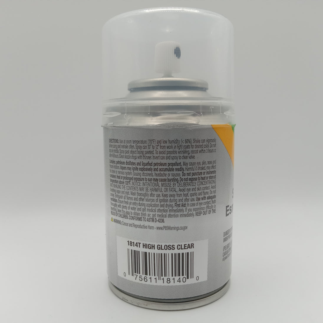 Spray paint can with label on a gray background