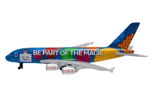 Colorful airplane model with 'Be Part of the Magic' text on a white background