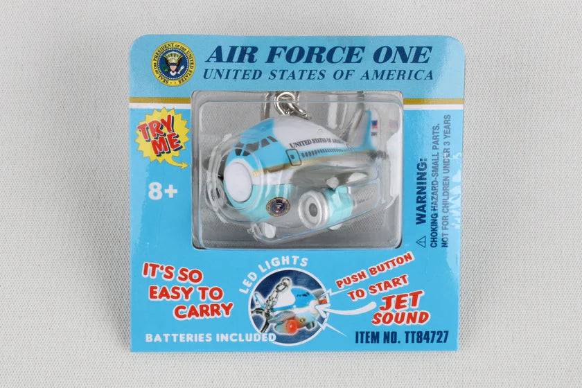 Toy airplane keychain in packaging with 'Air Force One' branding on a gray background