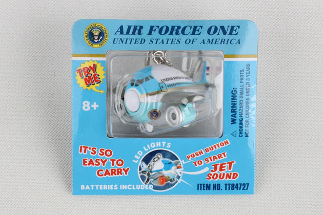Toy airplane keychain in packaging with 'Air Force One' branding on a gray background