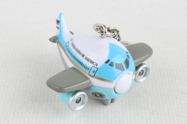 Toy airplane keychain with 'United States of America' text on a light gray background