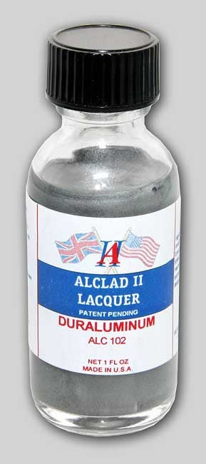 A bottle of Alclad II Dura Aluminum Lacquer Paint with a label indicating the color and product information.