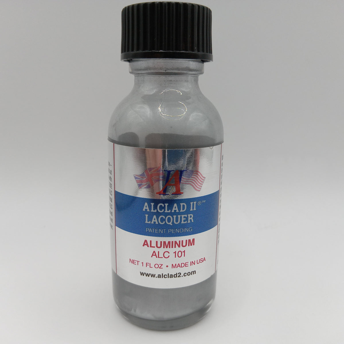 A small clear bottle of Alclad II Lacquer Aluminum Lacquer (ALC 101) with a black ribbed cap and a white, blue, and red label, set against a neutral gray background.