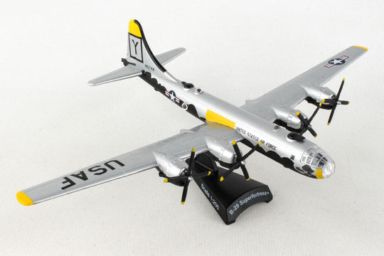 A die-cast metal model of the Postage Stamp B-29 Superfortress 'HAWG WILD' in 1/200 scale with a plastic stand, featuring the aircraft's markings and approximately 6 inches in length with an 8 1/8 inch wingspan.