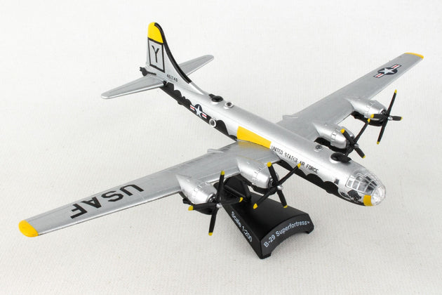 A die-cast metal model of the Postage Stamp B-29 Superfortress 'HAWG WILD' in 1/200 scale with a plastic stand, featuring the aircraft's markings and approximately 6 inches in length with an 8 1/8 inch wingspan.