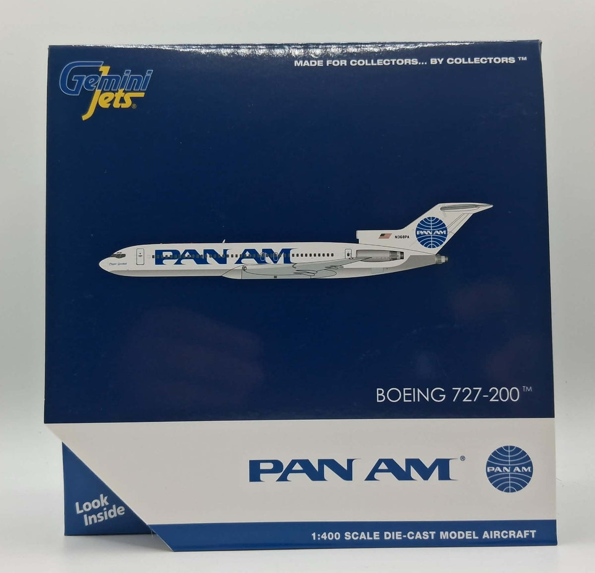 A boxed Gemini Jets model aircraft die-cast model, featuring a Pan Am Boeing 727-200. The packaging is dark blue with a white bottom section, displaying the Pan Am logo and a graphic of the white and blue model plane.