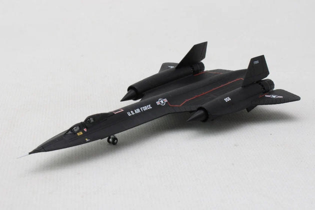 A black U.S. Air Force model jet model airplane on a light gray textured background.