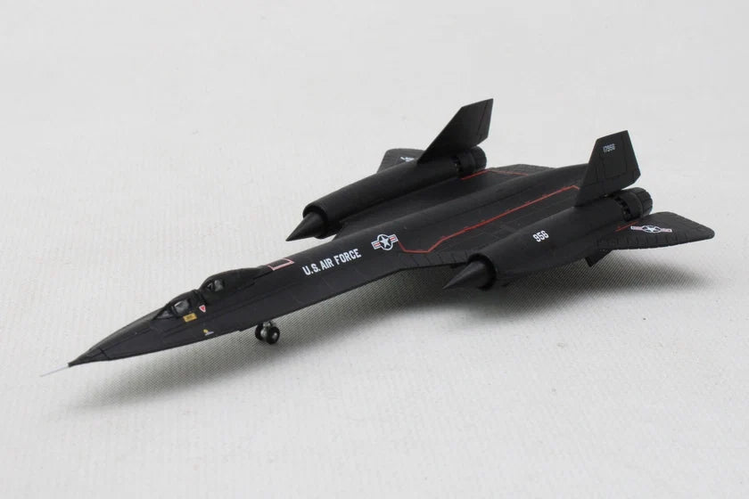 A black U.S. Air Force model jet model airplane on a light gray textured background.