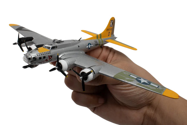 Hand holding a model airplane with a white background