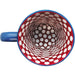A ceramic coffee mug with a yellow background and blue handle, featuring a bright red and white Polka Dot pattern on the inside.