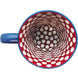 A ceramic coffee mug with a yellow background and blue handle, featuring a bright red and white Polka Dot pattern on the inside.