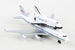 A white and black scale model of the United States Space Shuttle attached to a B-727 passenger jet, with NASA branding visible on the tail fin.