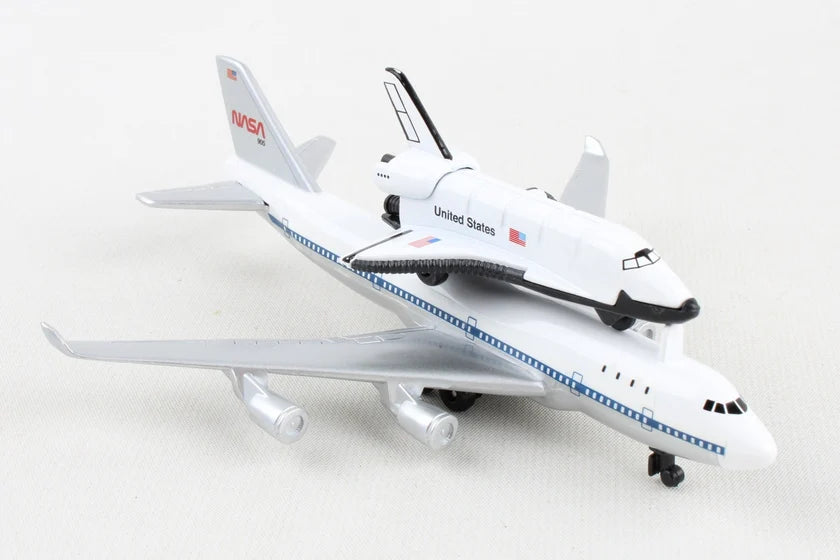 A white and black scale model of the United States Space Shuttle attached to a B-727 passenger jet, with NASA branding visible on the tail fin.