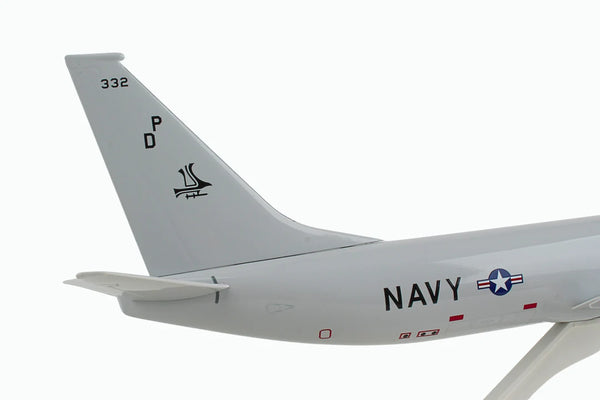 Close-up of a military aircraft tail fin with 'Navy' marking on a white background