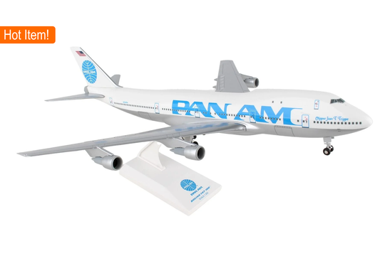 A model of a Pan Am 747-100 aircraft with landing gear, sitting on a display stand.