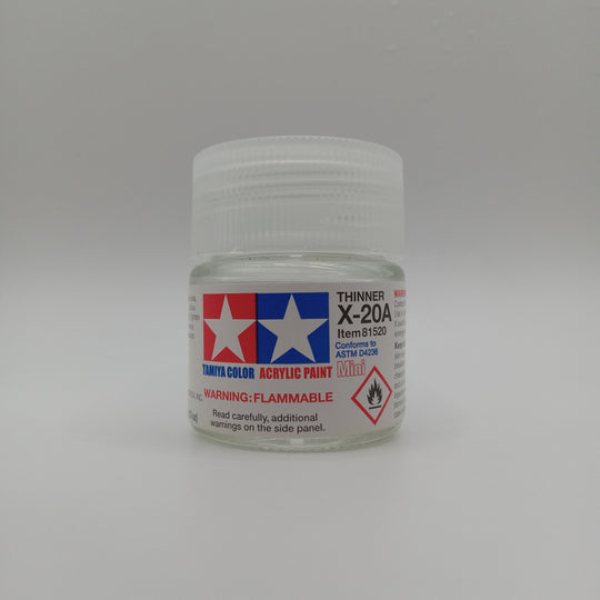A small jar of Tamiya Color X-20A Thinner acrylic paint on a neutral gray background.