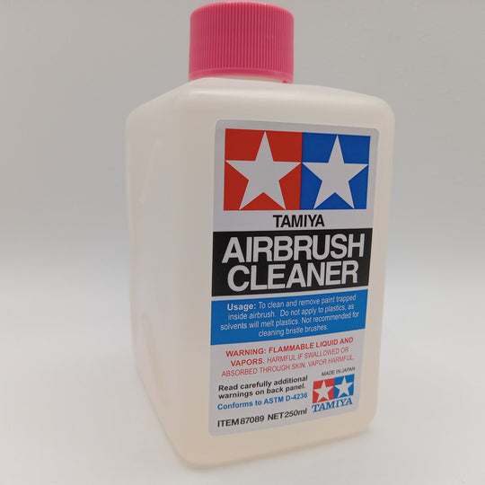 A 250ml bottle of Tamiya Airbrush Cleaner with a pink cap and a white label featuring the red and blue Tamiya logo, set against a plain light gray background.