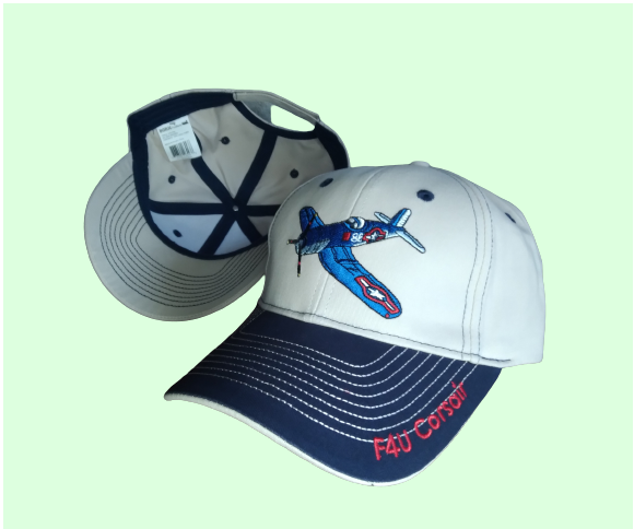 A two-tone embroidered hat with a Corsair aircraft design on the front and 'F4U CORSAIR' text on the brim.